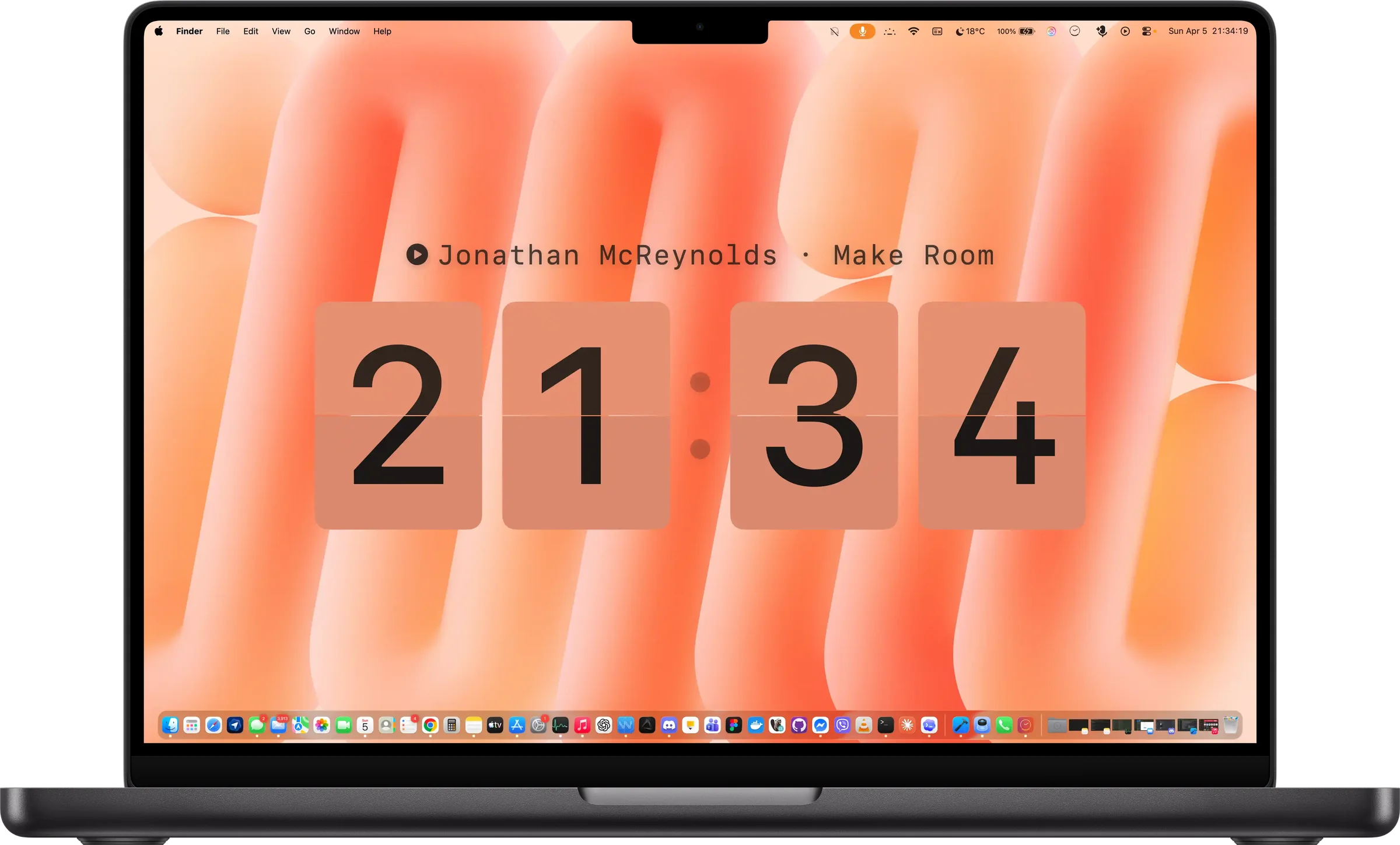 Cadran sur un MacBook Pro : une horloge à palettes sur le fond d’écran, avec le morceau en cours de lecture.